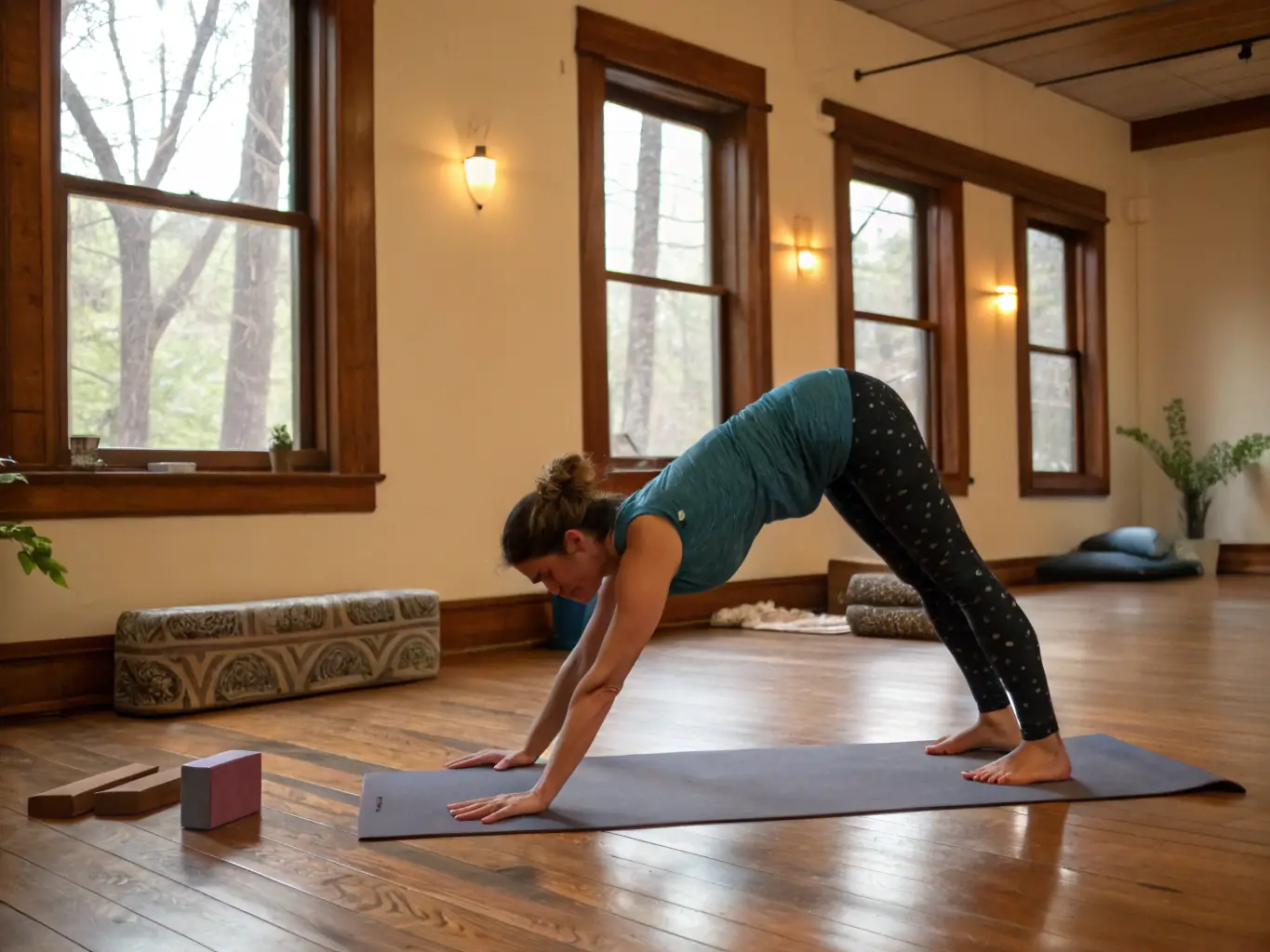 A lifestyle shot of a woman practicing yoga in a serene, minimalist studio, wearing Maison de Grace apparel and using a Maison de Grace yoga mat. The lighting is soft and natural, emphasizing the calm and focused atmosphere.
